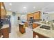 Well-lit kitchen features stainless steel appliances, granite countertops, and an island on tile flooring at 651 Glendora Rd, Kissimmee, FL 34759