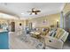 Bright living room features a ceiling fan, light colored wood floors, and comfortable seating at 651 Glendora Rd, Kissimmee, FL 34759