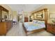 Well-lit main bedroom featuring a four-poster bed, wood floors and ample storage at 651 Glendora Rd, Kissimmee, FL 34759