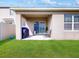 This covered back patio offers a relaxing outdoor space and overlooks the lush green lawn at 758 Lafayette Ln, Haines City, FL 33844