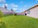 Lush, green backyard with a white fence, and a patio at 758 Lafayette Ln, Haines City, FL 33844