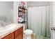 Cozy bathroom featuring a vanity, toilet, and shower with a decorative curtain at 758 Lafayette Ln, Haines City, FL 33844