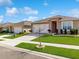 View of a well maintained house with an ample lawn and two car garage on a sunny day at 758 Lafayette Ln, Haines City, FL 33844