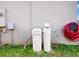 Exterior view of water filter, pipe, and red hose attached to the home's outside wall at 758 Lafayette Ln, Haines City, FL 33844