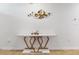 Stylish marble topped console table with gold accents under modern gold flower wall art at 758 Lafayette Ln, Haines City, FL 33844