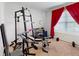 Well-equipped home gym with weightlifting equipment and bright red curtains at 758 Lafayette Ln, Haines City, FL 33844