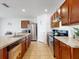 Spacious kitchen featuring cherry-wood cabinets, stainless steel appliances, and tile flooring at 758 Lafayette Ln, Haines City, FL 33844