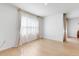 Open living room with wood floors, neutral walls, and sheer curtains covering a window at 758 Lafayette Ln, Haines City, FL 33844