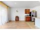 Open living space with wood flooring, a small cabinet, and stainless steel refrigerator at 758 Lafayette Ln, Haines City, FL 33844