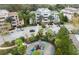 Aerial view of condominiums with ample parking, green spaces, and a playground at 7660 Whisper Way # 104, Reunion, FL 34747