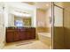 Bathroom with walk-in shower, soaking tub, double vanity and large framed mirror at 7660 Whisper Way # 104, Reunion, FL 34747