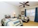 Bedroom featuring two twin beds, ceiling fan, and natural light at 7660 Whisper Way # 104, Reunion, FL 34747