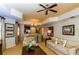 Living room view featuring neutral furniture, tray ceiling, and elegant chandelier at 7660 Whisper Way # 104, Reunion, FL 34747