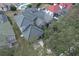 Aerial view of a beautiful home with a green tile roof surrounded by lush trees and landscaping at 7670 Milano Dr, Orlando, FL 32835