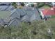 Aerial view of a beautiful home with a green tile roof surrounded by lush trees and landscaping at 7670 Milano Dr, Orlando, FL 32835