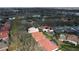 Picturesque aerial view of homes with colorful roofs and backyard pools nestled in a leafy neighborhood at 7670 Milano Dr, Orlando, FL 32835