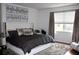 Modern bedroom with a plush rug, white trim, and a large window that provides natural light at 7670 Milano Dr, Orlando, FL 32835