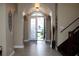 Inviting entryway with tile flooring, stairs, and a bright view of the outdoors at 7670 Milano Dr, Orlando, FL 32835