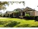 Charming one-story home features lush landscaping, a well-manicured lawn, and a tile roof at 7670 Milano Dr, Orlando, FL 32835