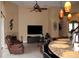 Open-concept living room featuring fireplace and view into the kitchen at 7670 Milano Dr, Orlando, FL 32835