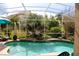 Screened pool and lanai area with lush landscaping create a private outdoor space at 7670 Milano Dr, Orlando, FL 32835