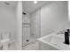 Bathroom featuring a toilet, shower with marble-look tile, dark accents, and a double sink vanity at 7904 Empire Ave, Orlando, FL 32810