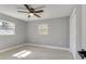 Bright bedroom with ceiling fan and natural light from two windows at 7904 Empire Ave, Orlando, FL 32810