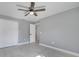 Neutral bedroom features a ceiling fan, closet, and light-colored floors at 7904 Empire Ave, Orlando, FL 32810