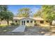 Charming one-story home featuring a bright yellow exterior and a well-manicured front yard at 7904 Empire Ave, Orlando, FL 32810