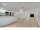 Kitchen featuring an open concept design with white cabinets, granite countertops, and stainless appliances at 7904 Empire Ave, Orlando, FL 32810