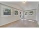 Bright sunroom with tile flooring, multiple windows and a glass door leading to the outside at 7904 Empire Ave, Orlando, FL 32810