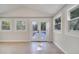 Bright sunroom with tile flooring, multiple windows and a glass door leading to the outside at 7904 Empire Ave, Orlando, FL 32810