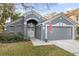 Charming gray single-Gathering home featuring an arched entryway, well-maintained lawn, and a two-car garage at 816 Garden Glen Loop, Lake Mary, FL 32746