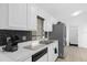 Bright kitchen featuring white countertops, a black backsplash, stainless steel sink, and modern appliances at 816 Garden Glen Loop, Lake Mary, FL 32746