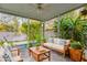 Inviting screened lanai featuring comfortable seating amidst lush greenery at 816 Garden Glen Loop, Lake Mary, FL 32746