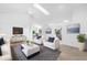 Bright living room with skylight, sleek furnishings, neutral tones, and modern decor, enhancing the spacious feel at 816 Garden Glen Loop, Lake Mary, FL 32746