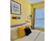 Yellow bedroom with a modern, stylish interior design at 8813 Dunes Ct # 7 201, Kissimmee, FL 34747