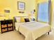 Bright bedroom with yellow walls, soft carpet, and modern decor at 8813 Dunes Ct # 7 201, Kissimmee, FL 34747