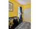 Bedroom with yellow walls boasts ample closet space and modern black furniture at 8813 Dunes Ct # 7 201, Kissimmee, FL 34747