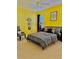 Sunny bedroom with yellow walls and stylish decor creates a cozy and inviting space at 8813 Dunes Ct # 7 201, Kissimmee, FL 34747