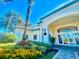 Clubhouse entrance with lush landscaping, creating a warm and inviting ambiance for residents and guests at 8813 Dunes Ct # 7 201, Kissimmee, FL 34747