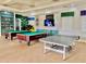 Inviting game room features billiard tables, ping pong, a television, and fun decor at 8813 Dunes Ct # 7 201, Kissimmee, FL 34747