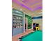 Game room includes pool table, arcade games, book case and fun colorful accents at 8813 Dunes Ct # 7 201, Kissimmee, FL 34747