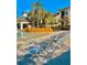 Resort-style pool with beach chairs, rock formations, and well-maintained landscaping at 8813 Dunes Ct # 7 201, Kissimmee, FL 34747