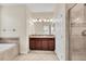 Well-lit bathroom with double vanity, granite countertops, a large mirror, and glass-enclosed shower at 8946 Azalea Sands Ln # 8946, Davenport, FL 33896