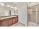 Elegant bathroom featuring a double vanity, granite countertops, and a modern glass-enclosed shower at 8946 Azalea Sands Ln # 8946, Davenport, FL 33896