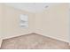 Bright, neutral bedroom with large window and cozy carpeting offers a serene space at 8946 Azalea Sands Ln # 8946, Davenport, FL 33896