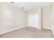 A carpeted bedroom with a double-door closet and neutral walls presents a blank canvas at 8946 Azalea Sands Ln # 8946, Davenport, FL 33896