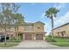 Charming two-story townhome with a brick driveway, attached garage, and lush landscaping at 8946 Azalea Sands Ln # 8946, Davenport, FL 33896