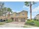 Inviting two-story townhome featuring a brick driveway and attached two-car garage at 8946 Azalea Sands Ln # 8946, Davenport, FL 33896